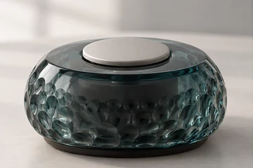 Textured glass form with a metal button