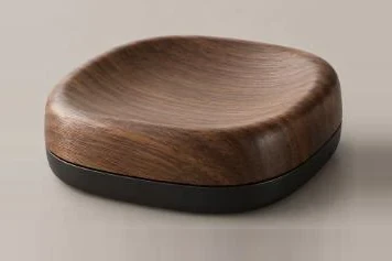 Sculpted walnut form on a black base